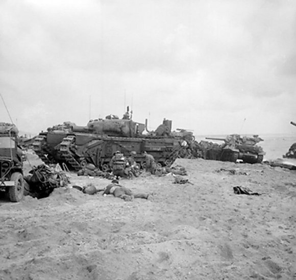 Medics tending the wounded by a Churchill AVRE vehicle of UK Royal Engineers 5th Assault Regiment, Sword Beach, Normandy, France, 6 Jun 1944; M10 Wolverine tank destroyer of 20th Anti-Tank Regiment