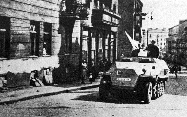 Polish resistance fighters with captured German SdKfz. 251 halftrack vehicle, Tamka Street, Warsaw, Poland, 14 Aug 1944, photo 2 of 3