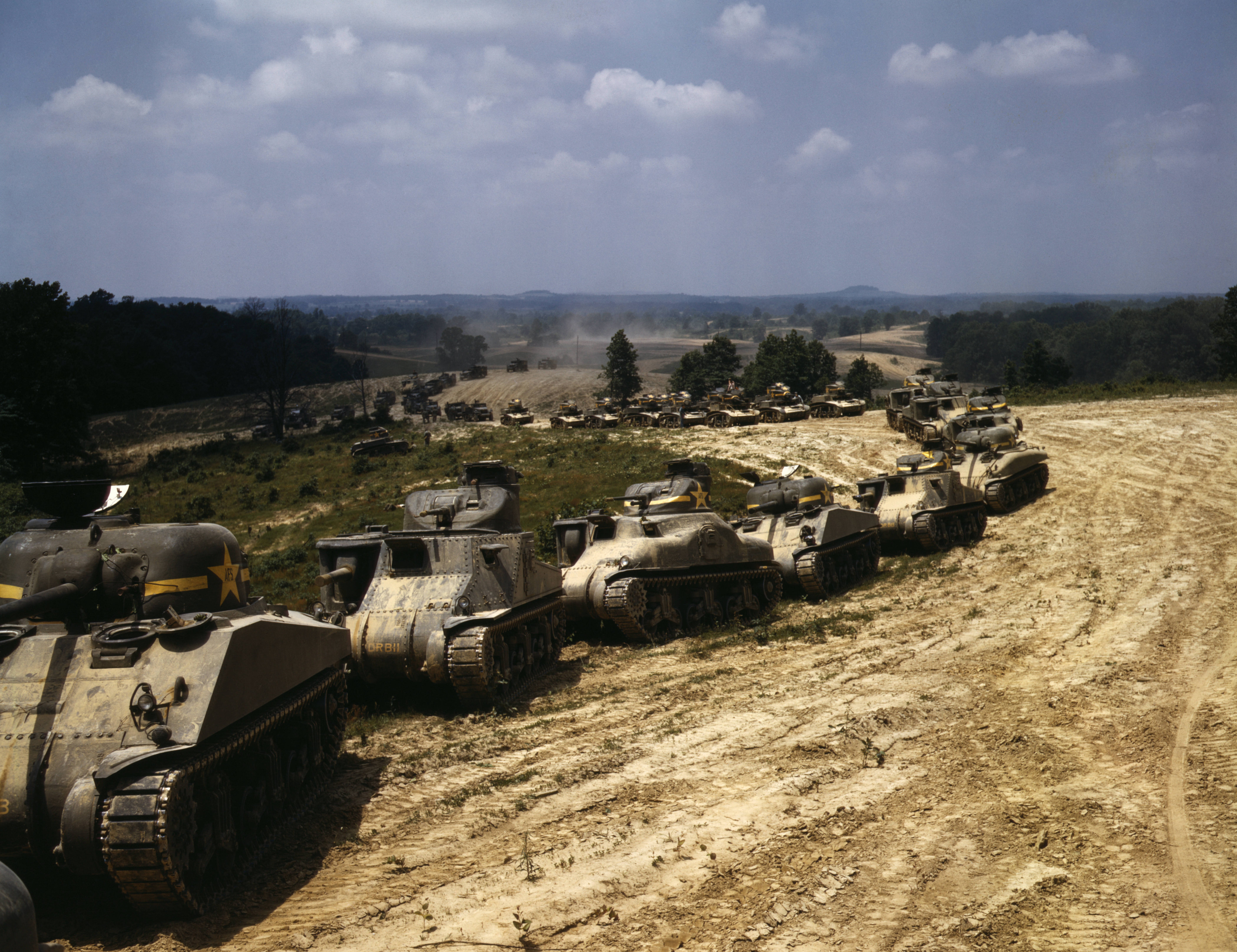 A column of M4 Sherman, M3 Grant, and M3 Stuart tanks in training maneuvers, Fort Knox, Kentucky, United States, Jun 1942