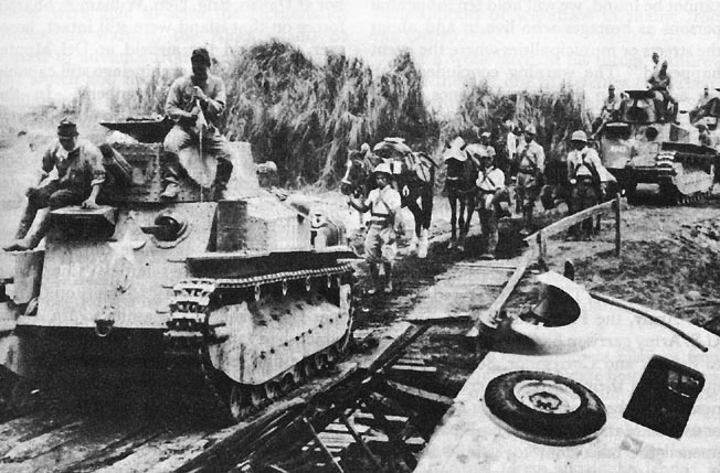 Japanese Type 89 I-Go medium tanks and troops moving toward Manila, Philippine Islands, 22 Dec 1941