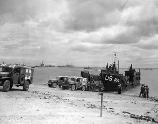 LCT-855 landing Dodge WC54 field ambulances at Normandy, France, Jun 1944