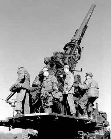 120 mm Gun M1 anti-aircraft weapon manned by men of Battery D, US 36th Anti-aircraft Artillery Gun Battalion during training, Fort George G. Meade, Odenton, Maryland, United States, Feb 1953