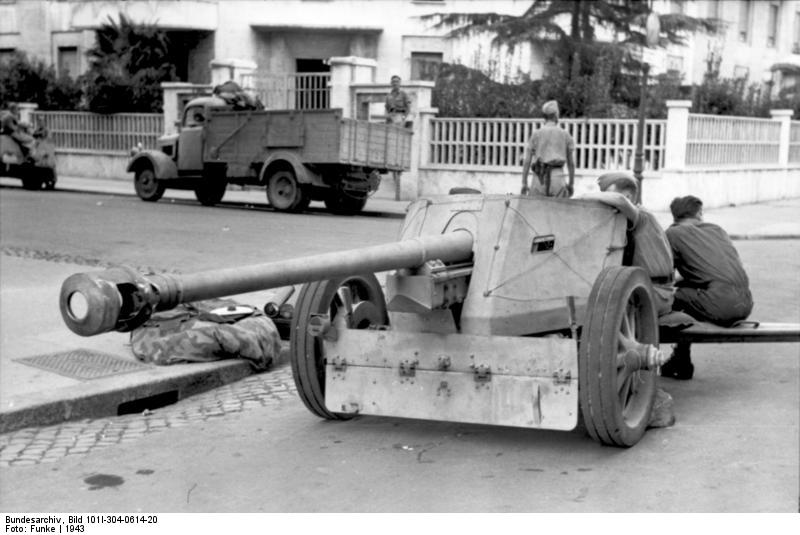 German crew of a 7.5 cm PaK 40 anti-tank gun resting in front of the Italian State Radio at the corner of Via Asiago and Via Montello, Rome, Italy, 11 Sep 1943.