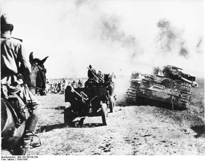 Soviet forces marching past a wrecked German Panzer IV tank, 1943-1945; note ZiS-3 gun being towed by horses