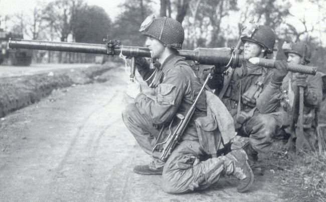 American Paratrooper with M3 knive, M1A1 carbine, and M18 recoilless gun, somewhere in Europe, 1944