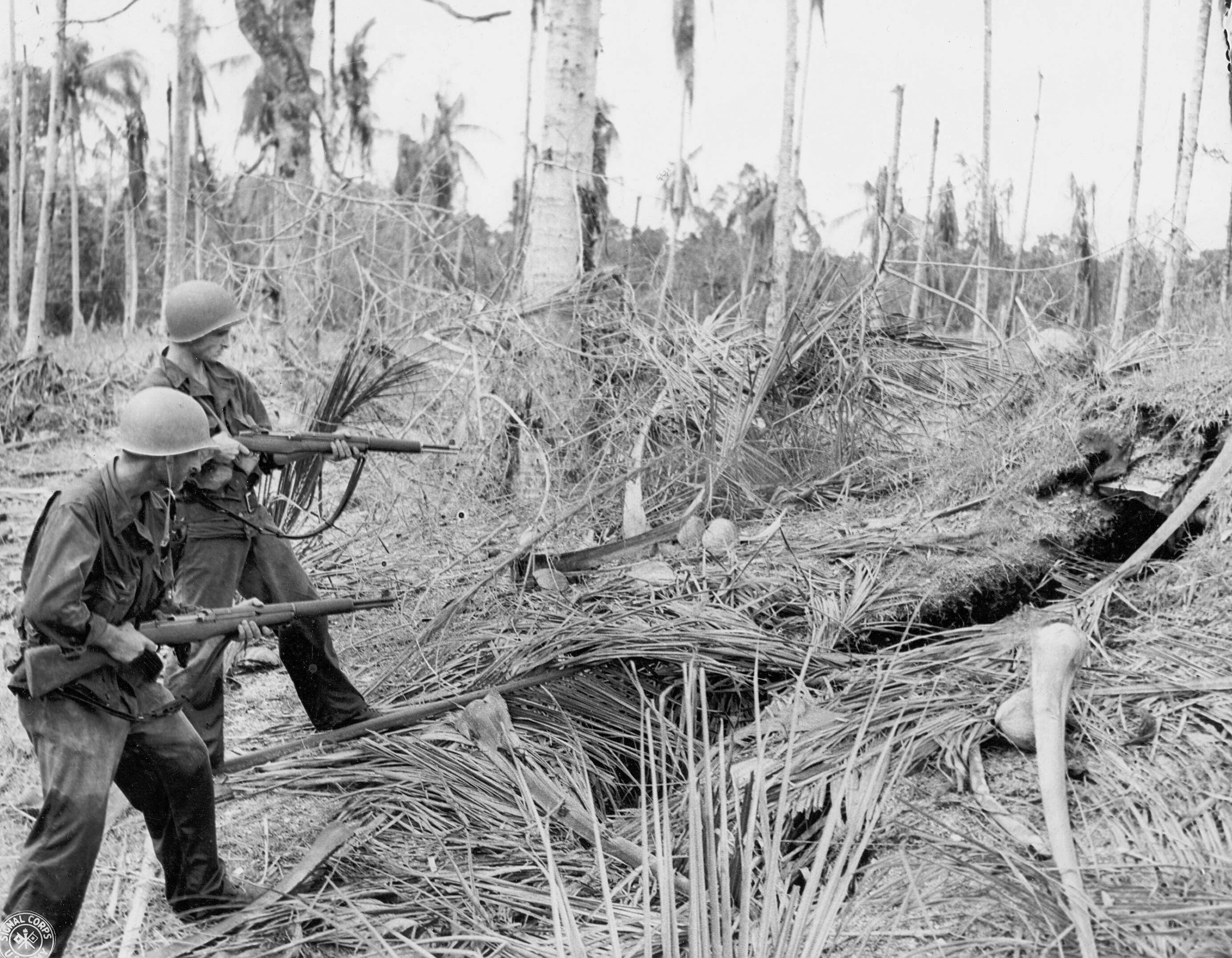 Soldiers of US 32nd Division probing a Japanese foxhole at New Guinea, Dec 1942; note M1 Garand rifles
