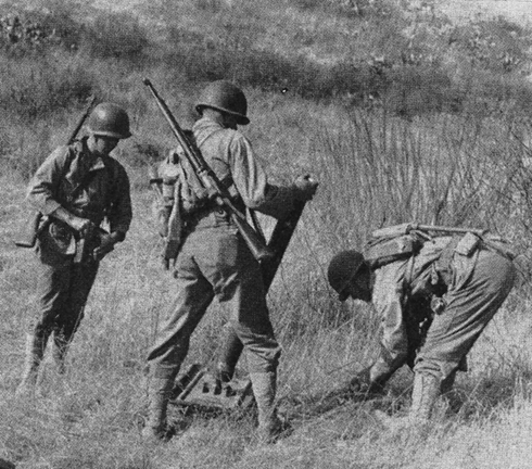 US Marine M1 mortar team putting together the weapon in exercise, Camp Pendleton, California, United States, 1943