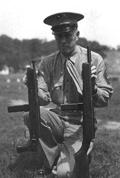 US Marine holding M55 Reising folding-stock (left) and M50 Reising (right) submachine guns, Marine Corps Base Quantico, near Triangle, Virginia, United States, date unknown