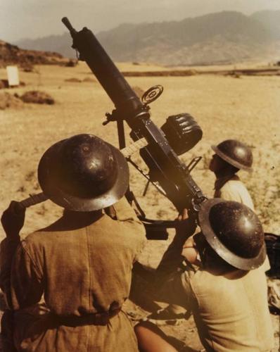 Chinese soldiers posing with a Type 24 machine gun in an anti-aircraft setup, China, circa 1940s, photo 2 of 2