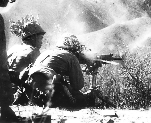 Japanese soldiers firing a Type 92 heavy machine gun, China, circa 1944